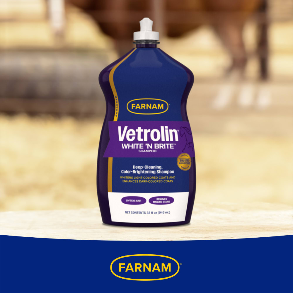 Bottle of Vetrolin white 'n brite shampoo on a table in a barn