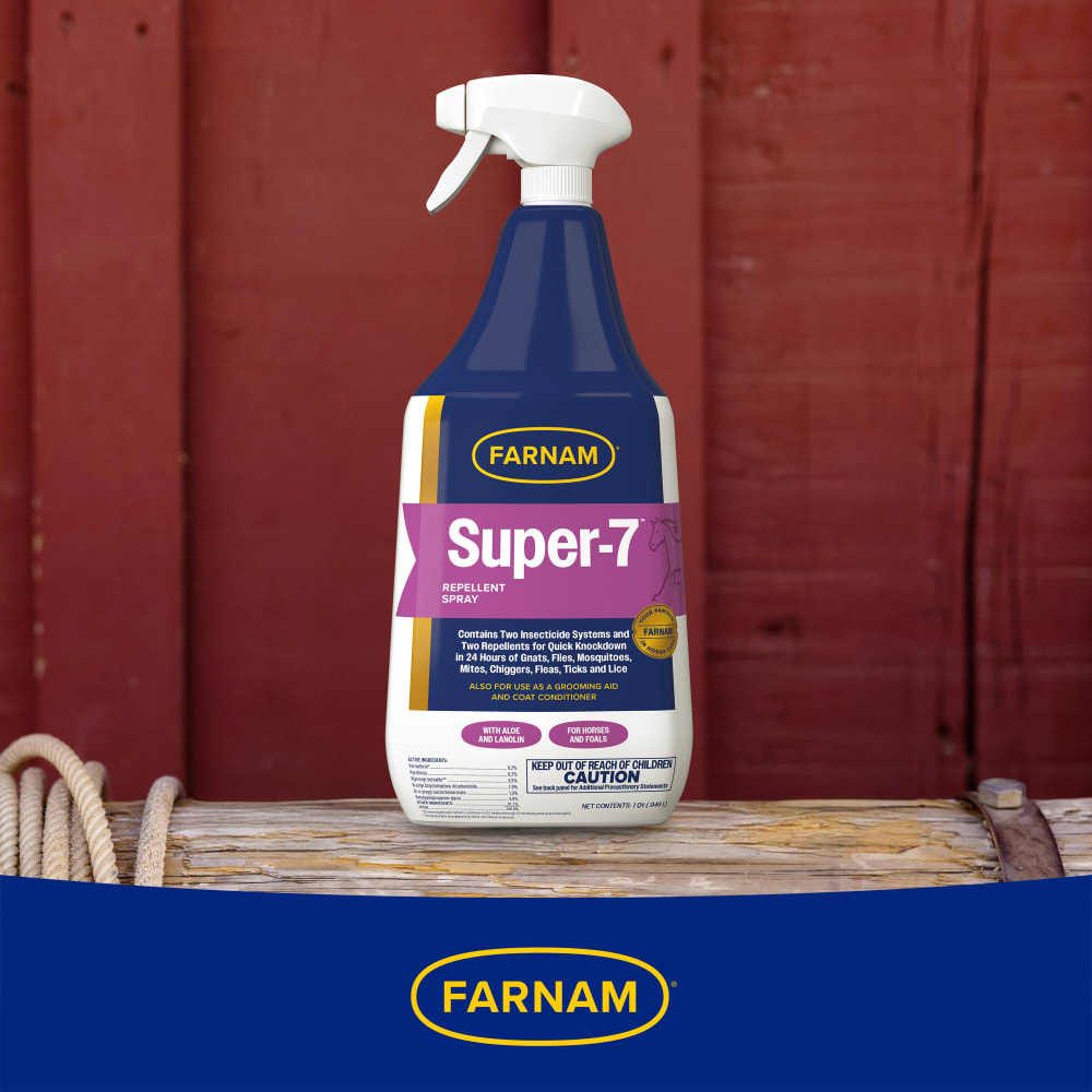 Super 7 repellent spray bottle on red wooden background