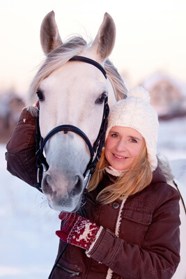 woman and horse in snow