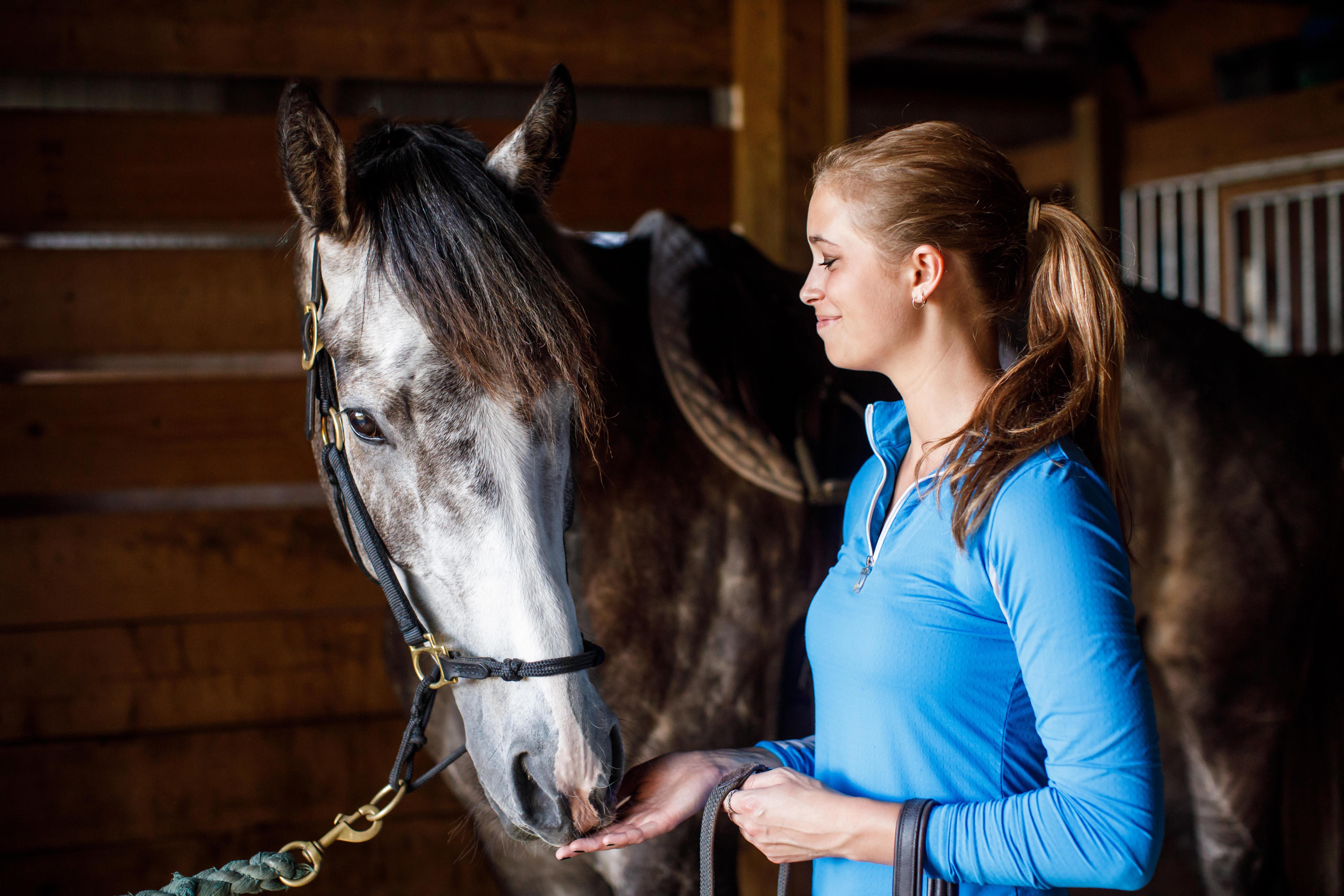 Girl with Horse in Barn Bonding